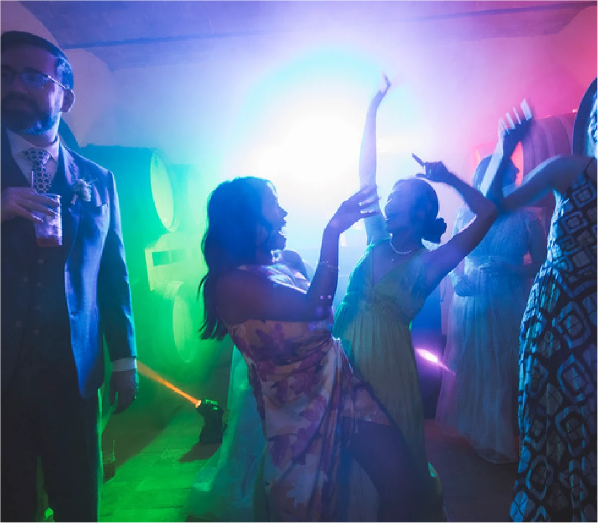 Dancing at an outdoor wedding reception under festoon lights
